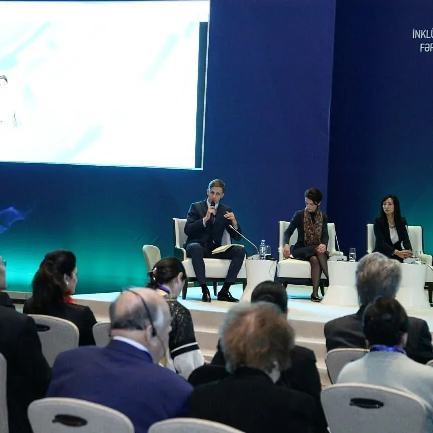 a panel session on stage before the forum audience