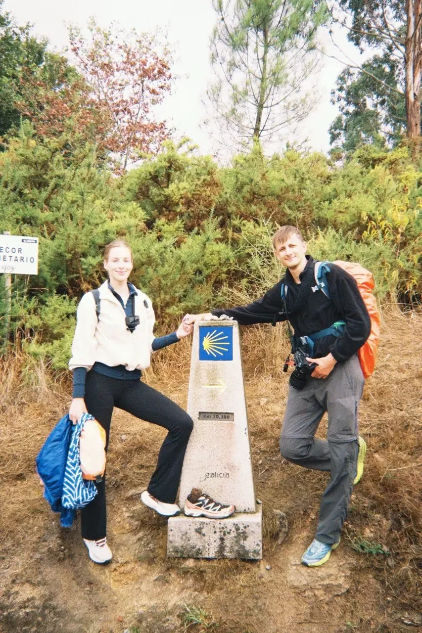 the two of us beside a camino waymarker in galicia