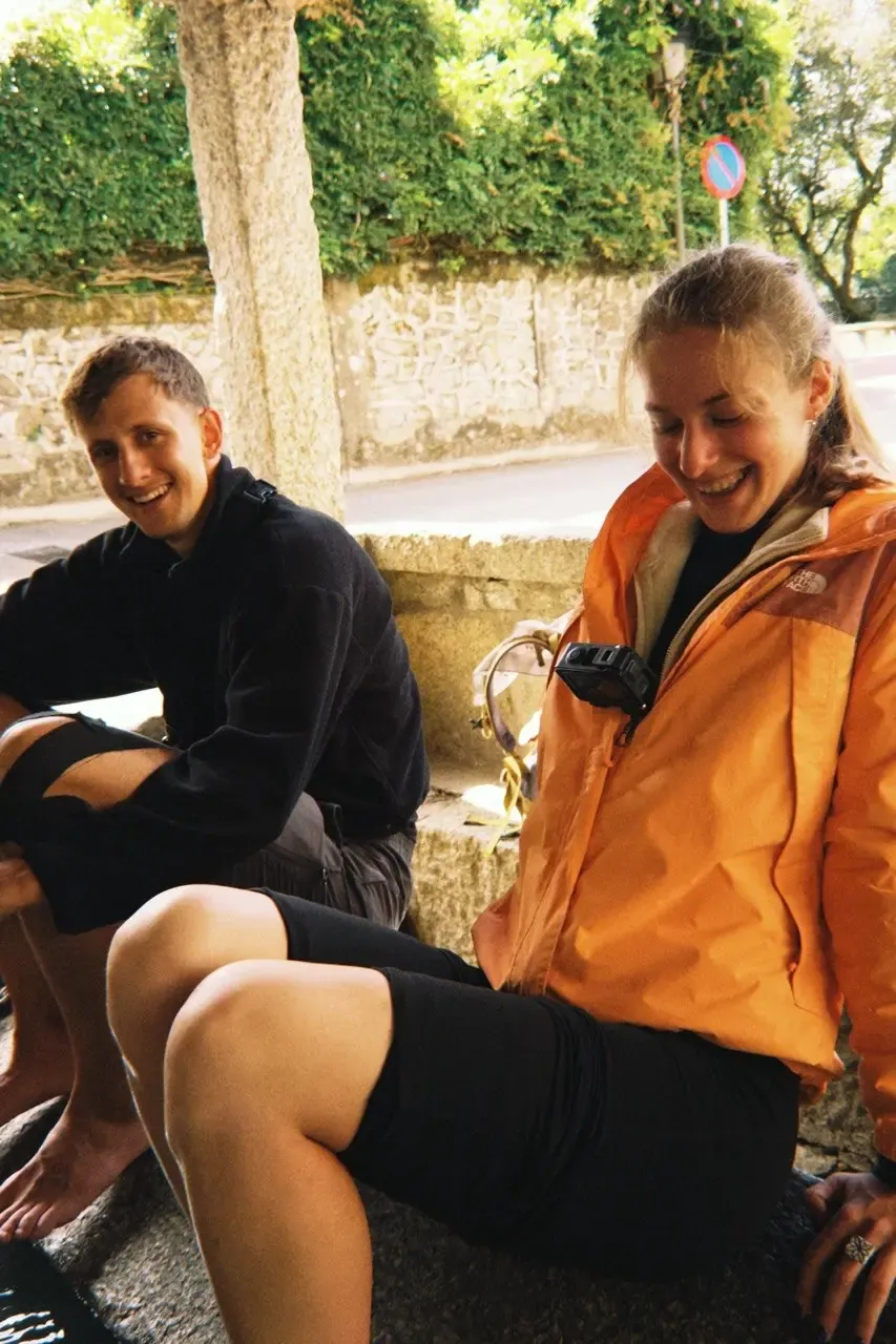 a break on a stone wall, boots off, both of us laughing