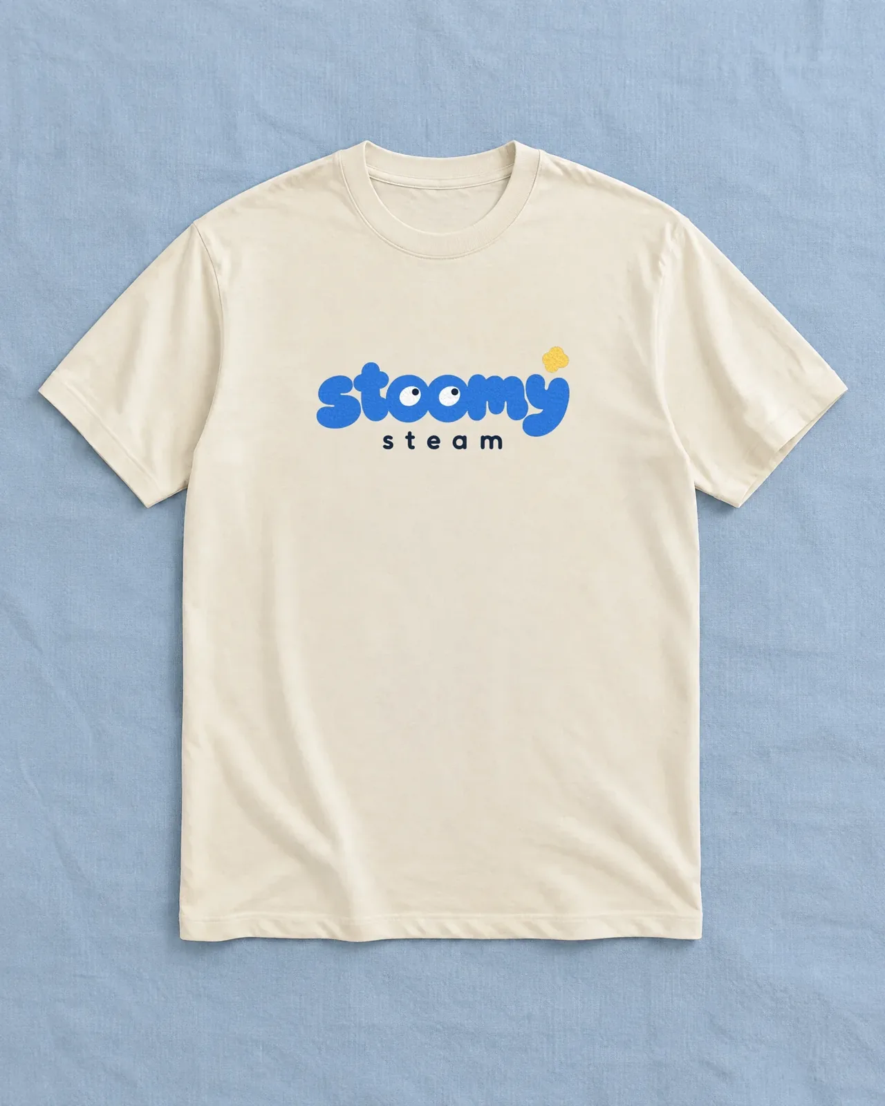Cream t-shirt with the Stoomy Steam logo on blue cloth — mockup
